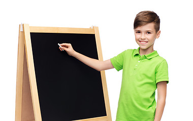 Image showing happy boy with chalk and blank school blackboard