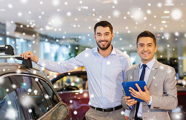 Image showing happy man with car dealer in auto show or salon