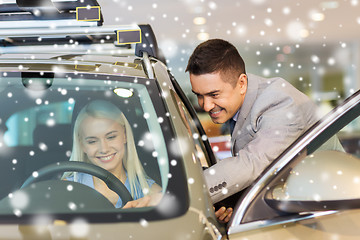 Image showing happy woman with car dealer in auto show or salon