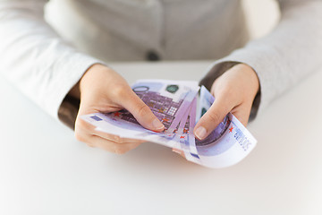 Image showing close up of woman hands counting euro money