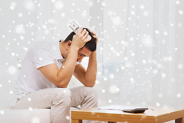 Image showing man with money and calculator at home