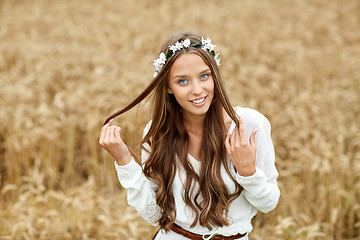 Image showing smiling young hippie woman on cereal field