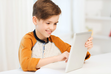 Image showing smiling boy with tablet pc computer at home