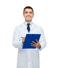 Image showing smiling male doctor with clipboard writing