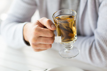 Image showing close up of man drinking tea at home or cafe