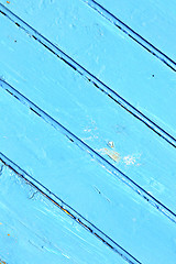 Image showing nail stripped paint in   blue wood door and rusty 