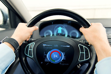 Image showing close up of man driving car with volume level icon