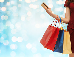 Image showing close up of woman with shopping bags and bank card