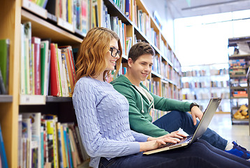 Image showing happy students with laptop in library