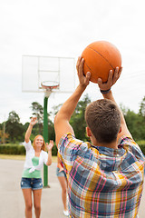 Image showing group of happy teenagers playing basketball