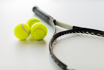 Image showing close up of tennis racket with balls