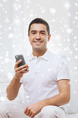 Image showing happy man with smartphone at home