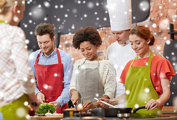 Image showing happy friends and chef cook cooking in kitchen