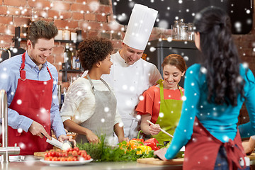 Image showing happy friends and chef cook cooking in kitchen