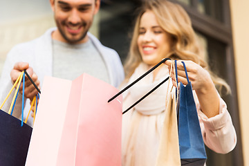 Image showing close up of couple with shopping bags on street