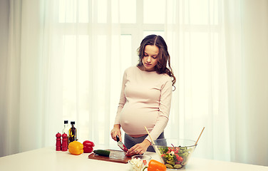 Image showing pregnant woman preparing food at home