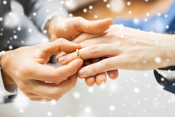 Image showing close up of male gay couple hands and wedding ring