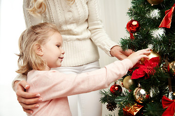 Image showing happy family decorating christmas tree at home