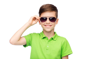 Image showing smiling boy in sunglasses and green polo t-shirt
