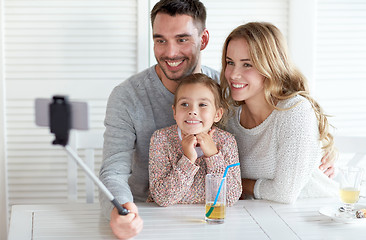 Image showing happy family taking selfie at restaurant