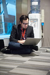 Image showing young business man in rush prepare conference presentation on la