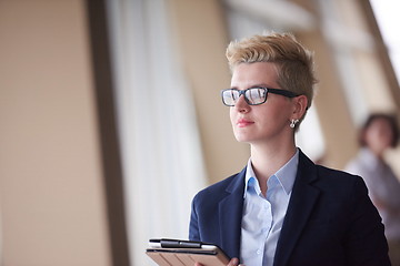 Image showing business woman  at office with tablet  in front  as team leader