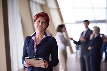 Image showing business woman  at office with tablet  in front  as team leader