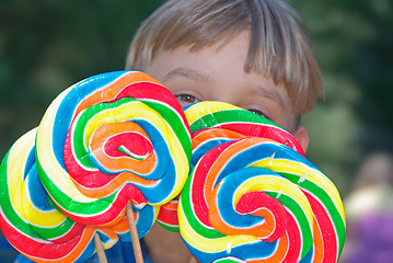 Image showing boy with lollipops