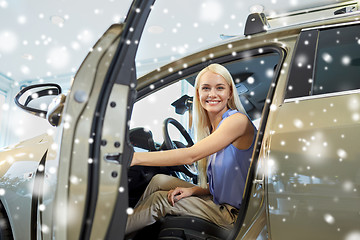 Image showing happy woman inside car in auto show or salon