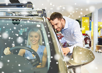 Image showing happy couple buying car in auto show or salon