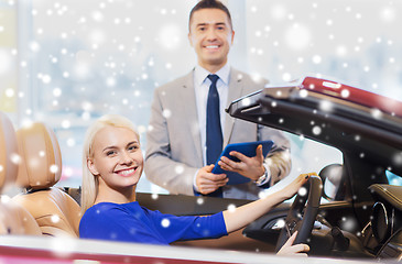 Image showing happy woman with car dealer in auto show or salon