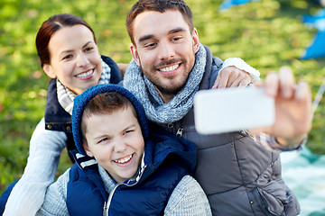 Image showing family with smartphone taking selfie at campsite