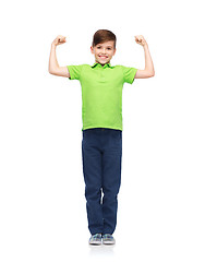 Image showing happy boy in polo t-shirt showing strong fists