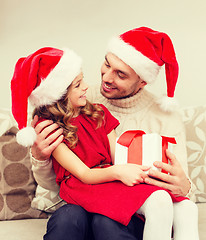 Image showing smiling father and daughter holding gift box