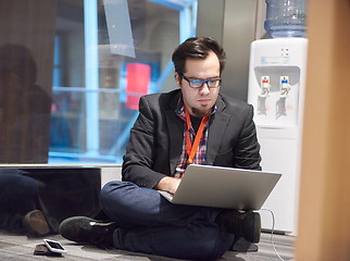 Image showing young business man in rush prepare conference presentation on la