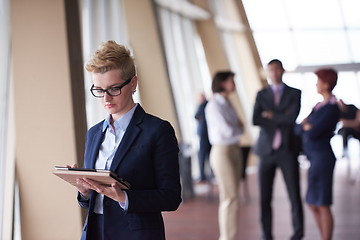 Image showing business woman  at office with tablet  in front  as team leader