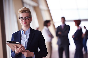 Image showing business woman  at office with tablet  in front  as team leader