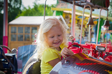 Image showing Child goes for a drive on a children\'s attraction