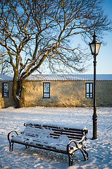 Image showing Bench and street lamp in the park winter Old Tallinn