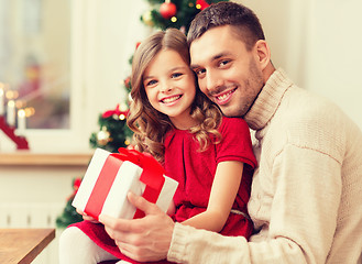 Image showing smiling father and daughter holding gift box