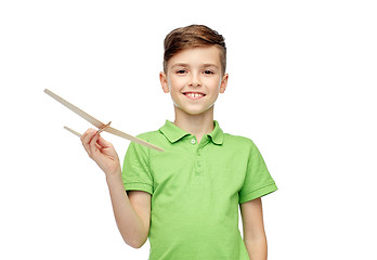 Image showing happy boy in green polo t-shirt with toy airplane