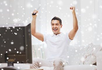 Image showing smiling man watching sports at home