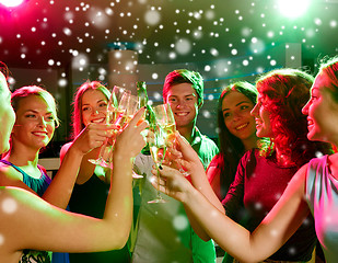 Image showing smiling friends with glasses of champagne in club