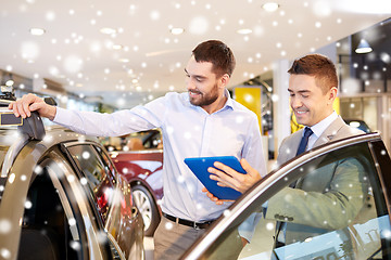 Image showing happy man with car dealer in auto show or salon