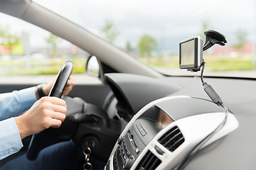 Image showing close up of man with gps navigator driving car