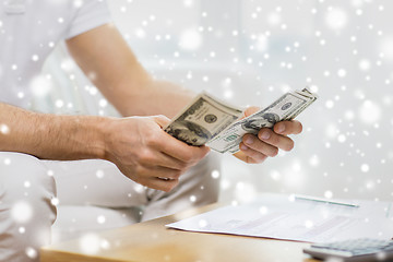 Image showing close up of man hands counting money at home