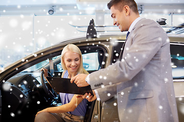 Image showing happy woman with car dealer in auto show or salon