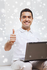 Image showing happy man working with laptop computer at home