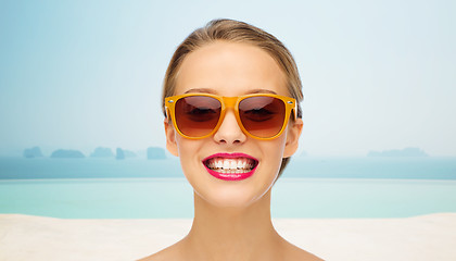 Image showing happy young woman in sunglasses with pink lipstick