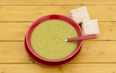 Image showing Chunks of bread with bowl of green soup